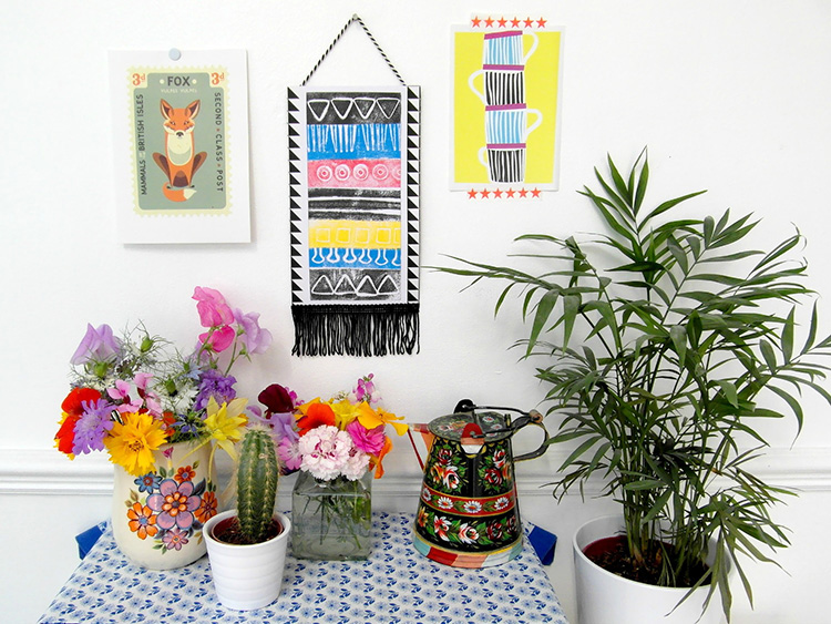 Bright aztec wall hanging created using ink pads and a moldable foam stamp