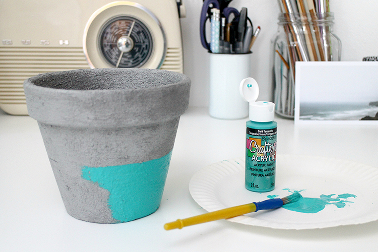 Painting the concrete pot with acrylic paint