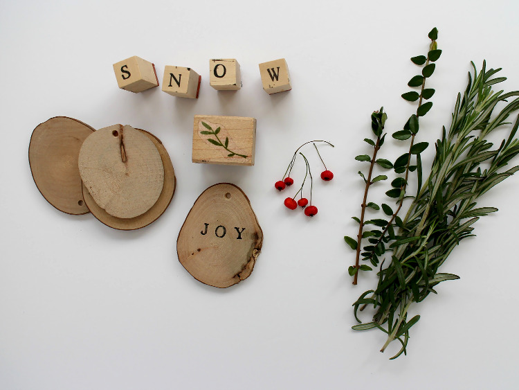 Wooden discs, letter stamps and winter foliage