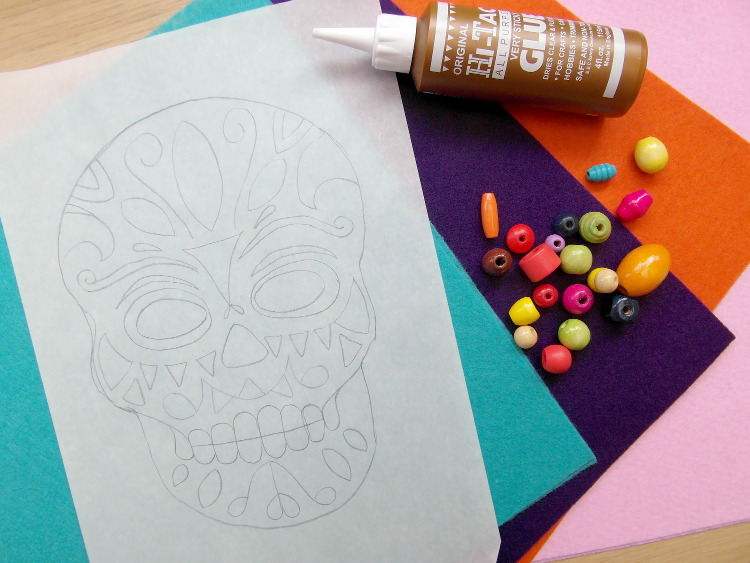 Coloured felt and a skull template used to make a Day of the Dead mask