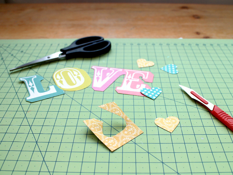 Cutting out the paper letters and hearts