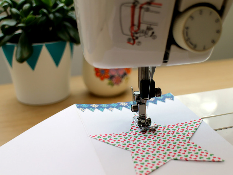 Stitching the scrapbook paper shapes into place