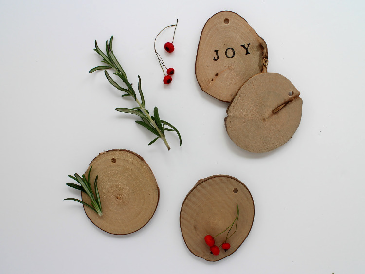 Wooden disc decorations with berries and rosemary