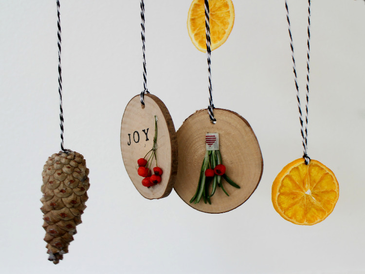 Festive wooden discs hung with pine cones and dried orange slices